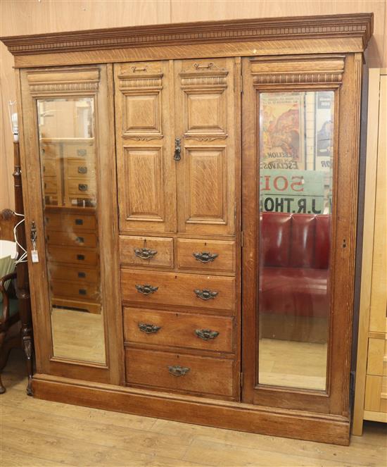 A late Victorian oak triple wardrobe W.193cm